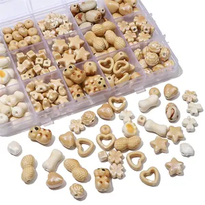 Assorted ceramic loose beads in earth tones with hearts and stars in a 15-grid storage box