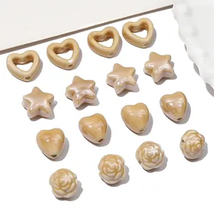 Glossy milk tea ceramic beads in heart, star, and rose shapes for DIY jewelry making