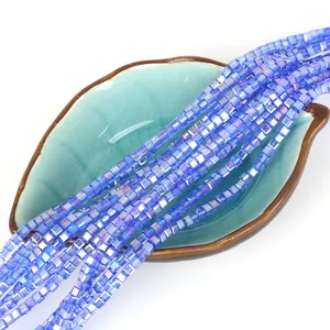 Blue square faceted crystal beads with AB coating on a ceramic leaf tray for DIY jewelry