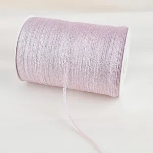Macro detail of pink glitter elastic ribbon roll for DIY crafts and gift wrapping