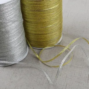 Metallic gold and silver glitter ribbons on rolls for gift wrapping and DIY crafts