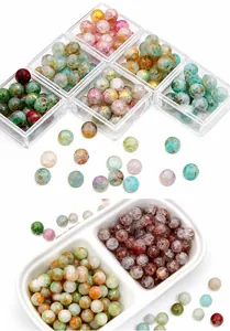 Macro shot of Morandi color cracked glass beads with gold accents for DIY jewelry