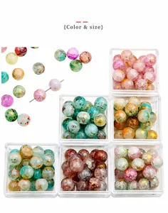 Macro shot of colorful crackle glass beads with gold glitter for DIY jewelry making