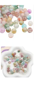 Macro detail of multicolored glass beads with gold foil flecks and marble textures