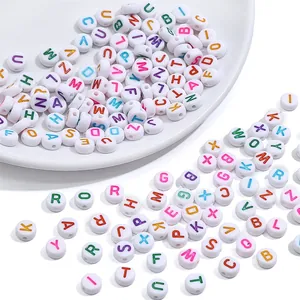 Detailed macro view of 4x7mm white acrylic alphabet beads with colorful letters for DIY craft
