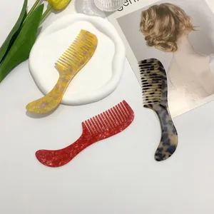 Vintage acetate wide-tooth hair combs in marble and tortoiseshell patterns