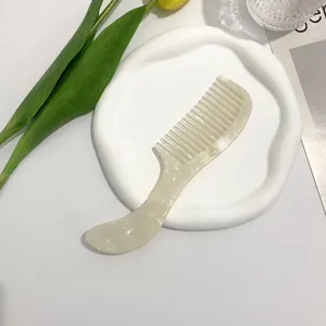 Detailed view of acetic acid hair comb with pearl texture on ceramic tray