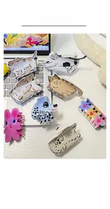 Gros plan de pinces à cheveux colorées avec motifs d'animaux comme dalmatien et lapin