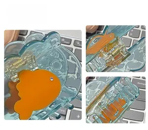 Macro detail of goldfish hair claw clip with blue acetate material and metal spring
