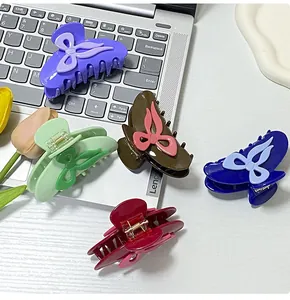Detail of colorful bow hair claws showing high-gloss finish and metal springs