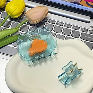 Blue translucent goldfish hair claw clips set in ceramic tray with tulip decor