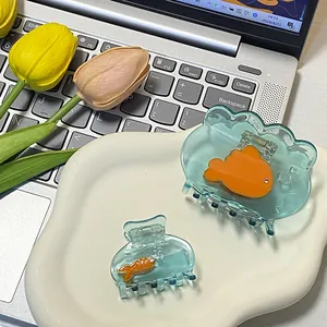 Goldfish design acetate shark hair claw clips in ocean blue set on white tray