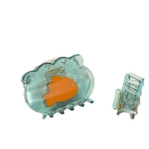 Ocean style blue goldfish hair claw clip with orange fish pattern and crystal detail