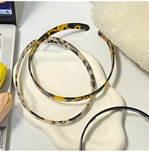 Close-up of thin acetate headbands with tortoise shell patterns and non-slip inner teeth