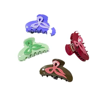 Set of four colorful acetic acid bow hair claws in purple, green, red and brown colors