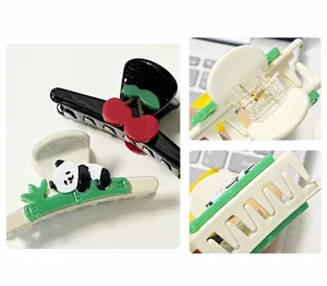 Detail of panda and cherry hair clips with durable metal springs and smooth teeth