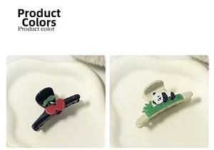 Detail view of cute panda and cherry resin hair clips in black and cream white colors