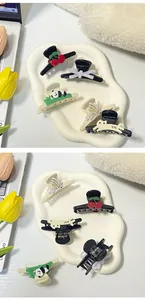 Macro detail of various cute panda and cherry hair clips made of high-quality resin