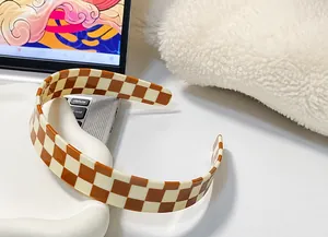 Detail of vintage checkerboard headband in brown and beige with a matte finish