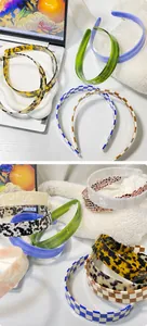 Close-up of checkerboard and tortoiseshell hairbands with glossy acetate finish