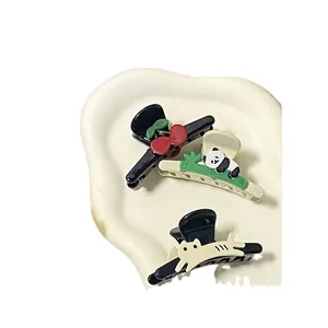 Three-piece set of cute panda and cat hair clips on a wavy display tray