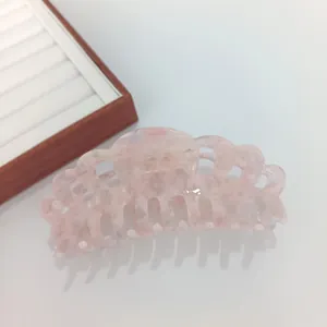 Detail of pink marble acetate hair claw clip showing smooth finish and sturdy teeth