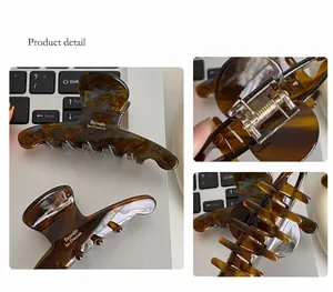 Detailed macro view of amber tortoise shell hair claw with durable metal spring mechanism