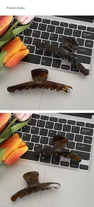 Detail showing amber tortoise shell hair clips with Barrette La France gold lettering