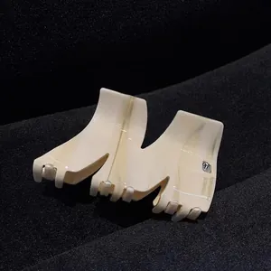 Detail of cream marble acetate hair claw clip with silver M-shaped letter design