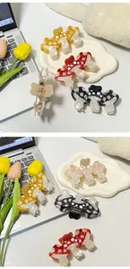 Detail view of colorful mushroom hair claws with polka dots and metal spring mechanism