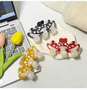 Detailed close-up of cute mushroom hair claws with colorful polka dot patterns