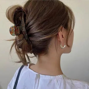 French style tortoise shell acetate hair claw clip shown on elegant model hairstyle