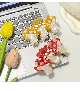 Close-up of acetic acid mushroom hair clips on a laptop with vibrant tulip decor