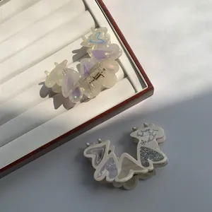 Elegant heart-shaped acetic acid hair claws with iridescent finish and glitter details