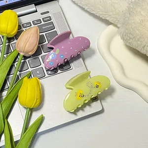 Haarklammern mit Blumen- und Bienenmuster aus Acetat mit Strass auf Dekotablett