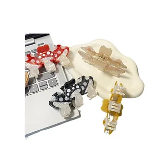Creative acetate mushroom hair claw clips set with cute polka dot patterns on a laptop