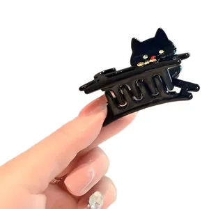 Pinza per capelli a forma di gatto in acetato nero lucido con dettagli in strass