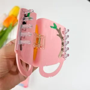 Pink cup-shaped acetate hair claw clip with tree branch pattern for women's hairstyles