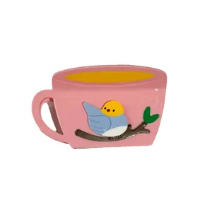 Pink teacup shaped hair clip featuring a blue bird on a branch acetate hair claw