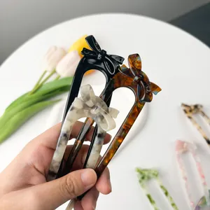 Classic U-shaped acetate hair fork with bow design in black, tortoiseshell and marble