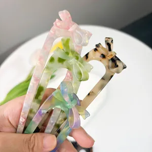 Classic French acetate bow U-shaped hair pins in marble and leopard print patterns
