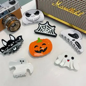 Close-up of Halloween hair claw set with pumpkin, bat, ghost and spider web designs