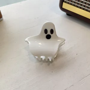 Detailed view of a white ghost-shaped acrylic hair claw clip for Halloween fashion