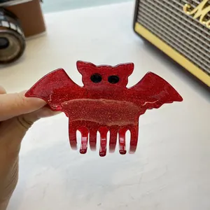 Close-up of glittery red bat hair claw clip with high-quality acrylic finish