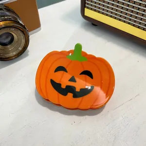 Halloween pumpkin hair claw clip with orange jack-o-lantern design for festive hair styling