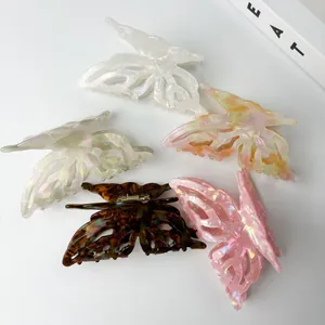 Detailed macro view of five iridescent butterfly hair claws in acetate and pearl finish