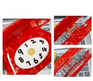 Macro detail of red marble texture acetate hair claw in vintage telephone clock design