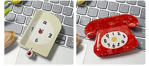 Detail of retro clock and rotary phone hair claws in acetate with creative patterns