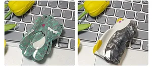 Detail of cartoon dinosaur and penguin hair claws made from premium acetate material