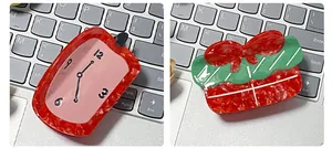 Detailed view of artistic acetate hair claws in Dali melting clock and gift box shapes
